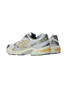 Sapatilhas Asics Gel 1130 amarelo e prateado para mulher.