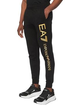 Calça Emporio Armani EA7 preta e dourada para homem.